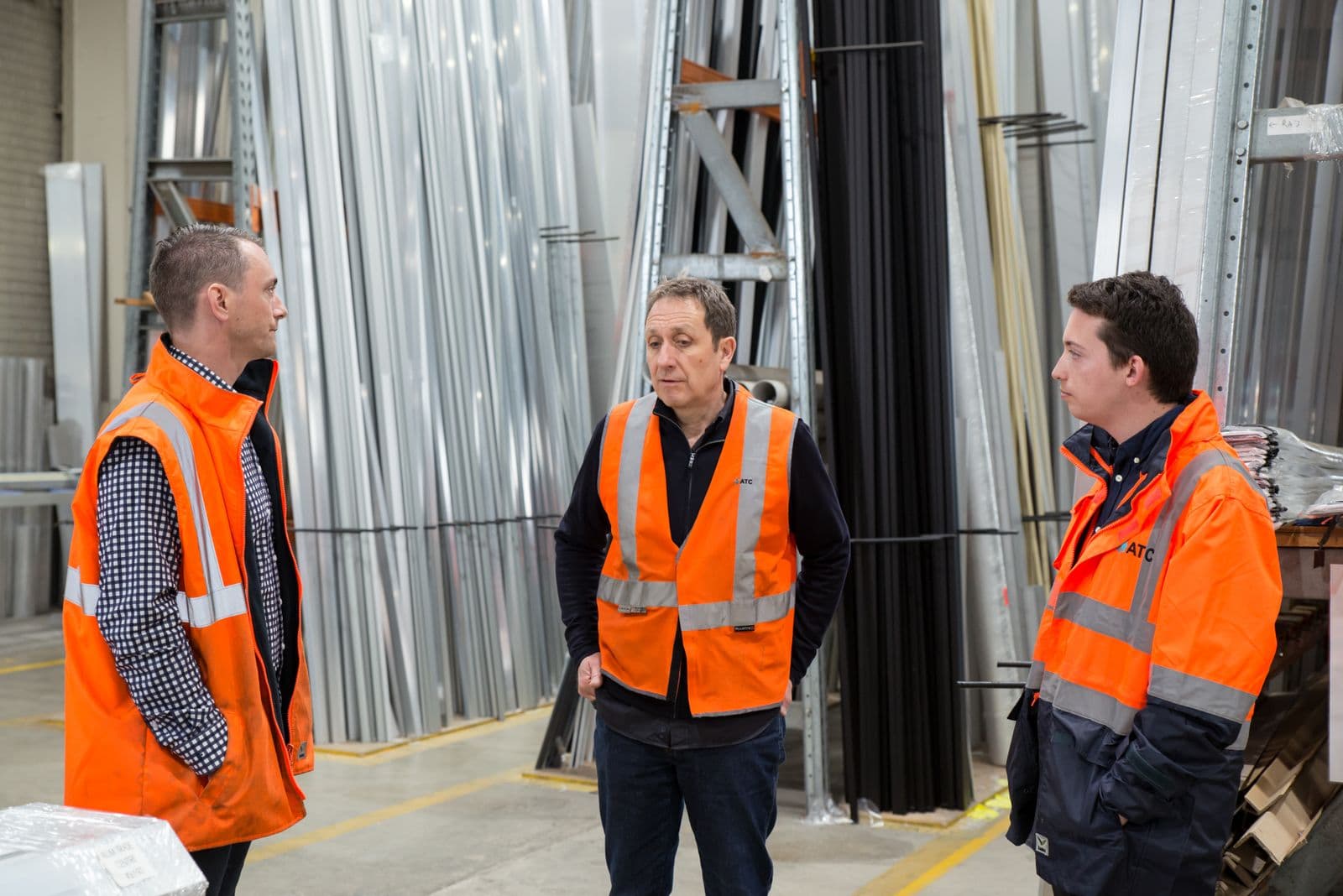 An operations team reviewing priorities on a manufacturing floor
