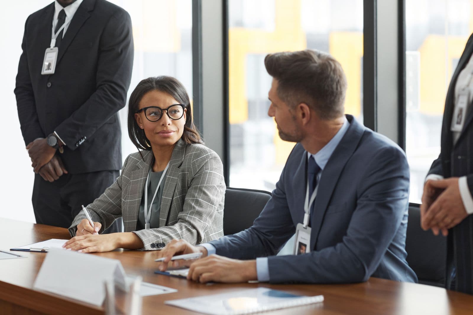 Professionals in a boardroom discussing strategy and a transaction